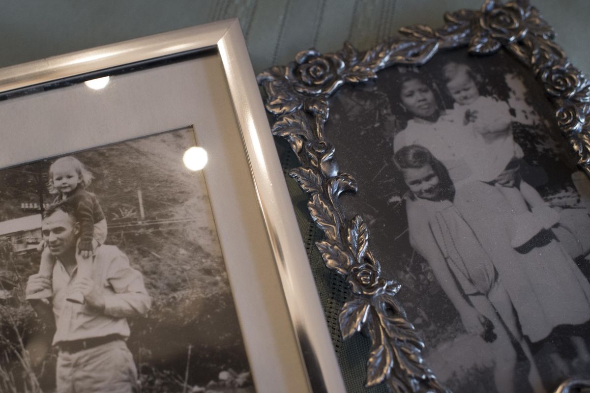 Sharon Kromholtz, then Crawford, left, is pictured on the shoulders of her father, Paul Crawford, and, at right, in the arms of  a nanny with her sister, Pauline, shortly before the Japanese invasion of the Philippines. The photos are seen Wednesday, Jan. 31, 2018, in Spokane. (Tyler Tjomsland / The Spokesman-Review)