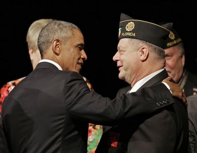 President Barack Obama greets a legionnaire after speaking Tuesday at the American Legion national conference convention in Charlotte, N.C. (Associated Press)