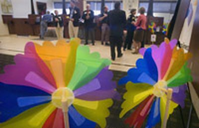
Pinwheels frame American West Bank's lobby Friday as Project Safe Place is announced.
 (Christopher Anderson / The Spokesman-Review)
