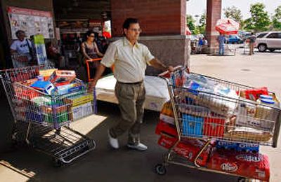 
Carlos Garda shops Friday at the Costco warehouse in Glendale, Calif. Consumer confidence rebounded in July as retail sales rose  at clothing stores by 1.3 percent  and at department stores and general merchandise stores  by 0.9 percent. Associated Press
 (Associated Press / The Spokesman-Review)