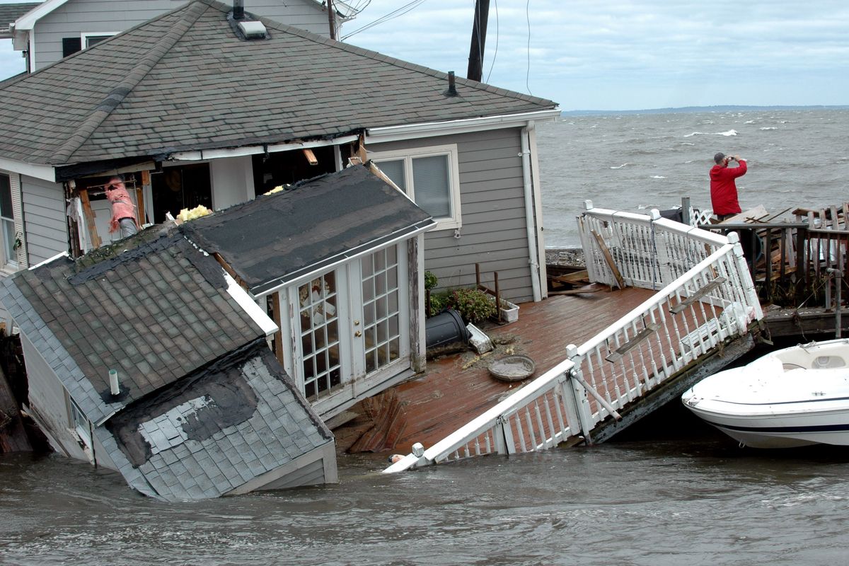 A home was submerged in Pine Creek in Fairfield, Conn., as Tropical Storm Irene came through the area Sunday. (Associated Press)