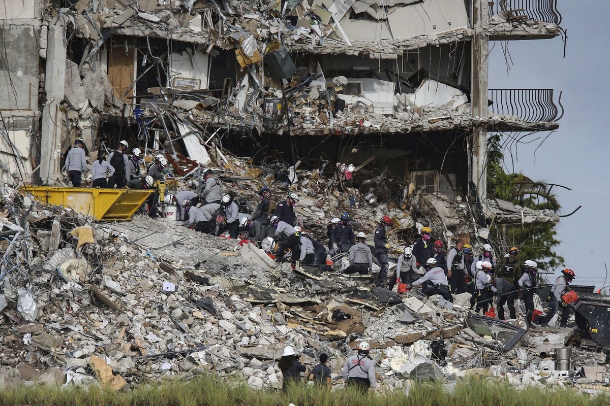 Search and rescue teams look for survivors Tuesday at the Champlain Towers South residential condo in Surfside, Fla.  (Al Diaz)