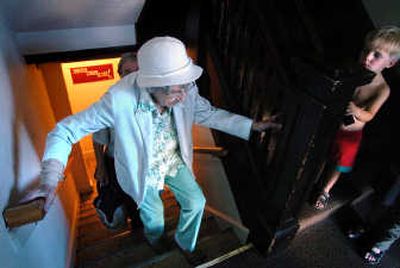 
Thomas Van Buskirk, 4, watches Vivian Warnke, 91, climb the stairs from the Free Restaurant in the basement of St. Paul's United Methodist Church. 
 (INGRID BARRENTINE / The Spokesman-Review)