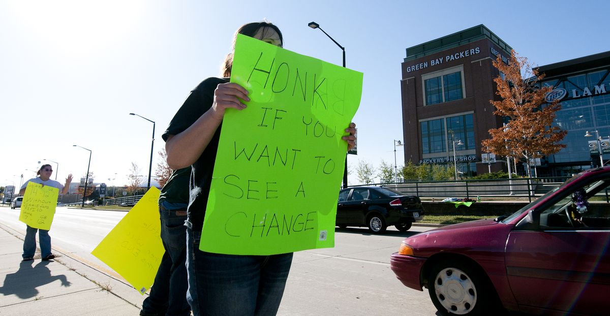 Alicia Schadrie holds a sign Tuesday, Sept. 25, 2012 on Lombardi Avenue in Green Bay, Wisc., in protest of a controversial call in the Packers 14-12 loss to the Seattle Seahawks, Monday night in Seattle. Just when it seemed that NFL coaches, players and fans couldn