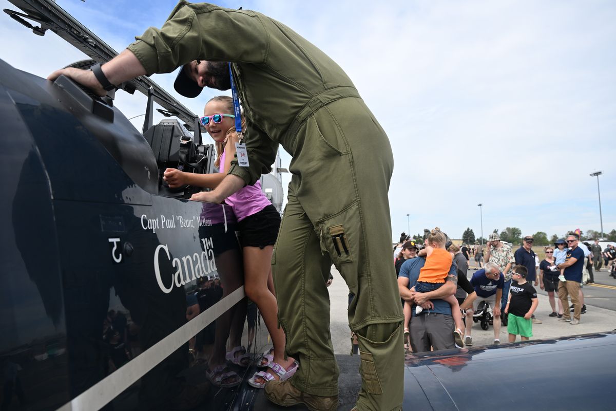 Aria Davey, 7, quizzes Canadian Air Force pilot Igor Vukalija about the cockpit of his CT-156 training aircraft at the Skyfest airshow Saturday at Fairchild Air Force Base.  (Jesse Tinsley/THE SPOKESMAN-REVIEW)