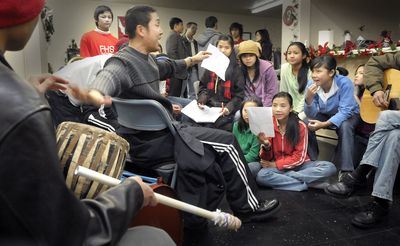 James, who uses only one name, reaches back to stop the drumming of Eh Hser during a rehearsal for the KaRen refugee community of Burma’s holiday celebration. The community gathers at Jacob’s Well on East Fifth in Spokane to prepare for the six-hour celebration Dec. 27.  (CHRISTOPHER ANDERSON / The Spokesman-Review)