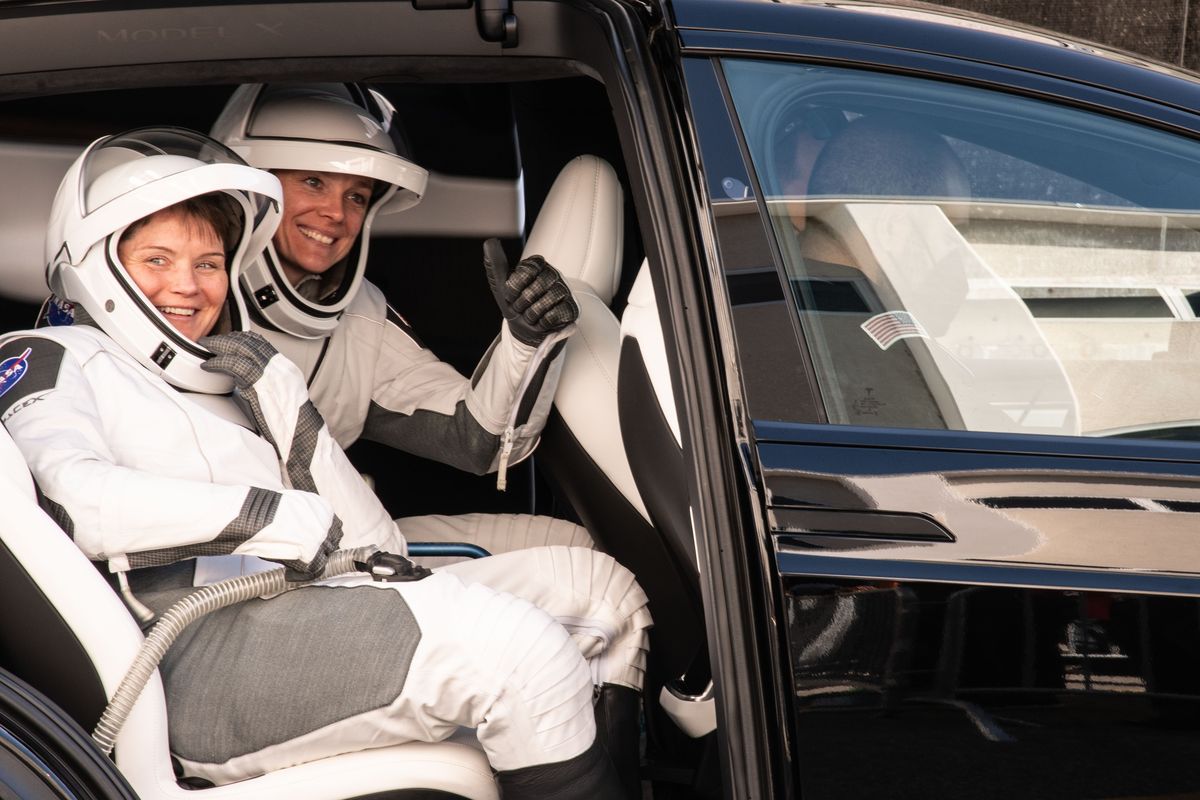 NASA astronauts Anne McClain, left, and Nichole Ayers smile at their respective loved ones from the back of a black Tesla model Y used to transport Crew-10 to launchpad 39a on Wednesday at the Kennedy Space Center. Nick Gibson won best series for his work on the launch. (Nick Gibson / The Spokesman-Review)