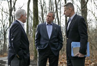 
In this photograph provided by the White House, President Bush, center, discusses Iraq policy with Secretary of Defense Robert Gates, left, and Chairman of the Joint Chiefs of Staff Gen. Peter Pace at Camp David on Saturday.
 (Associated Press / The Spokesman-Review)