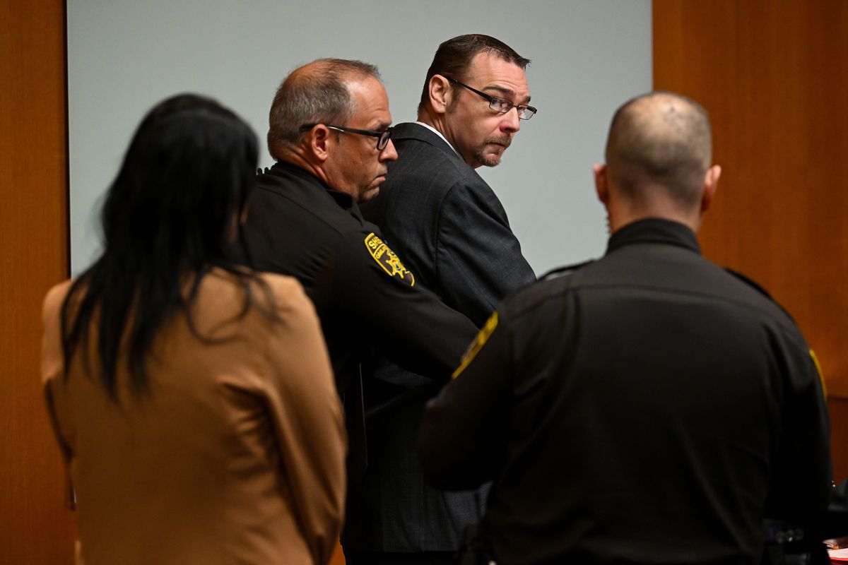 James Crumbley (second from right) has his waist chains removed by a bailiff during his trial at the Oakland County Courthouse as Judge Cheryl Matthews swears in the jury on March 7, 2024, in Pontiac, Mich. MUST CREDIT: Joshua Lott/The Washington Post  (Joshua Lott/The Washington Post)