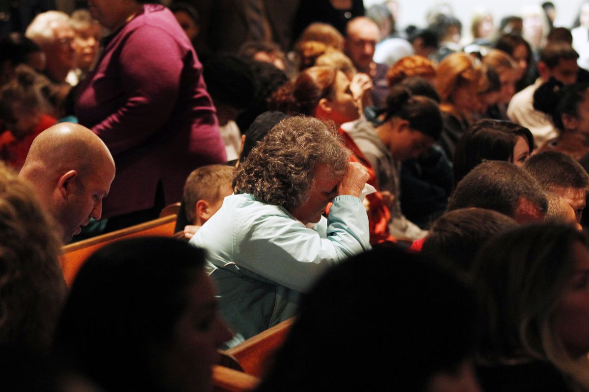 Mourners react during a packed overflow service at Clayton Baptist Church Tuesday, Oct. 23, 2012, in Clayton, N.J., as the small town tries to begin healing after missing 12-year-old Autumn Pasquale was found dead. Her body was found around 10 p.m. Monday, just blocks away from her house. Gloucester County Prosecutor Sean Dalton said two teenage brothers were charged Tuesday with murdering Pasquale, who had been missing since the weekend, prompting a frantic search by her small hometown. (Mel Evans / Associated Press)