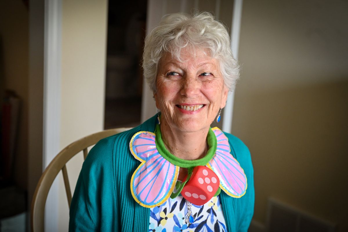 Diane Phillips won the horor of wearing the dice collar after rolling 3 1s in a game of Bunko, Monday, April 10, 2023, in Spokane.  (DAN PELLE/THE SPOKESMAN-REVIEW)