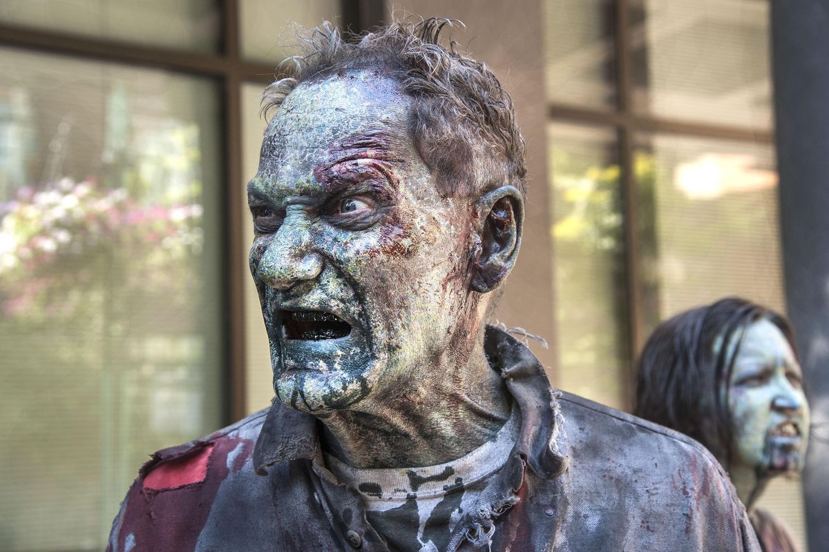 “Z Nation” actors Jerry Dykeman and Brie Edwards wait on Wall Street in downtown Spokane to shoot a zombie scene  Friday. (Dan Pelle / The Spokesman-Review)