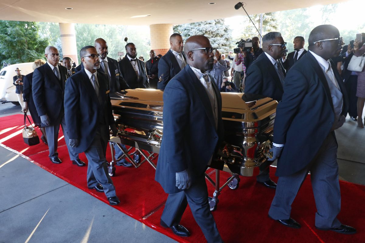 Pallbearers carry the gold casket of legendary singer Aretha Franklin after arriving at the Greater Grace Temple in Detroit, Friday, Aug. 31, 2018. Franklin died Aug. 16 of pancreatic cancer at the age of 76. (Paul Sancya / Associated Press)