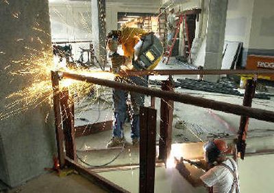 
Ironworkers John South, left, and Mike Danielson grind and weld on a second-floor railing as work continues on the new West Valley High School on Tuesday. 
 (The Spokesman-Review)