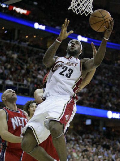 
Cleveland's LeBron James gets inside New Jersey's Josh Boone for a basket. 
 (Associated Press / The Spokesman-Review)