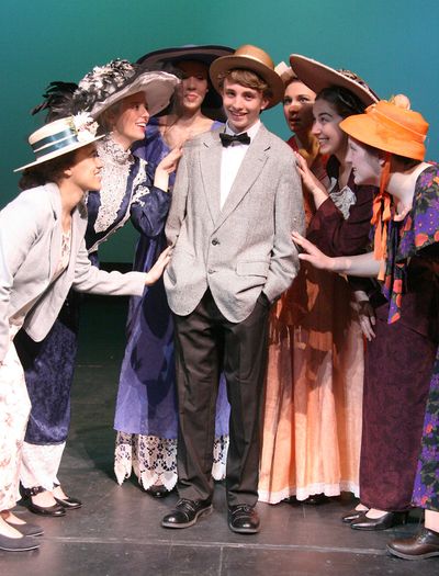 Professor Harold Hill, played by Jack Morrow, is surrounded by admirers (from left, Drew Doughty, Alaina Jacobsen, Natalie Johnson, Stephanie Hammett, Emily Guinn, and Malinda Wagstaff) in St. George’s School’s production of “The Music Man.”