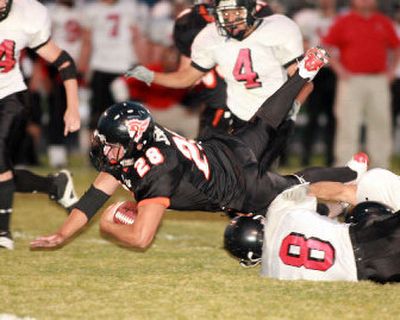 
Jon Aune of Post Falls stretches for a first down in the Trojans' 22-16 win over visiting Cheney on Friday night. 
 (Cory Murdock / The Spokesman-Review)