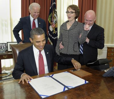 President Barack Obama signs the Ultralight Aircraft Smuggling Prevention Act of 2012, Friday, with Vice President Joe Biden, former Arizona Rep. Gabrielle Giffords, and her husband, Mark Kelly, in attendance. (Associated Press)