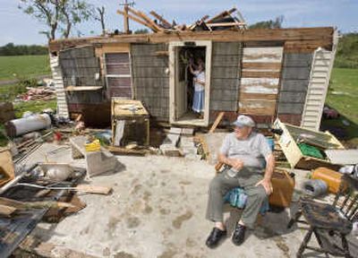 
Jack Payton, 72, sits in front of his hurricane-damaged home Thursday as his wife, Connie, removes a wreath from the front door.Associated Press
 (Associated Press / The Spokesman-Review)