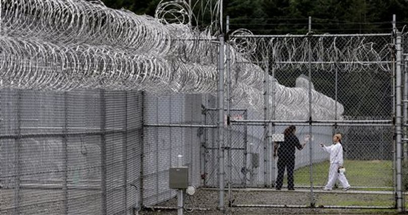 In this photo taken Oct. 17, 2014, a correctional officer, left, directs an offender through a gate at the Washington Corrections Center For Women in Gig Harbor, Wash. A 2003 federal law was meant to put a stop to sexual assault in the nation’s prisons, jails and juvenile detention centers and more than $110 million in state and federal taxpayer money has been spent to help states tackle the problem. By last fall, every state was supposed to have dozens of new standards in place, ranging from increased training of staff about sex abuse policies to procedures meant to help inmates safely report attacks. (AP / Elaine Thompson)