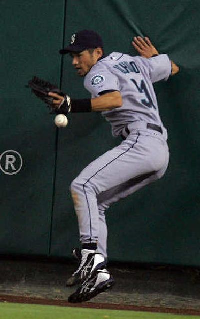 
Ichiro Suzuki can't get a glove on a double off the wall by Garret Anderson.
 (Associated Press / The Spokesman-Review)