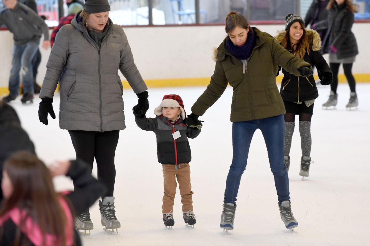 Erika Whittaker, left, and friend Courtney Aadland-Lewis, right, take Raymond Aadland-Lewis, 3, for his first day of ice skating, Sunday Feb. 26, 2017, at the Ice Palace in Riverfront Park. It was the last day at the rink before it is disassembled as part of the parks redesign. (Jesse Tinsley / The Spokesman-Review)