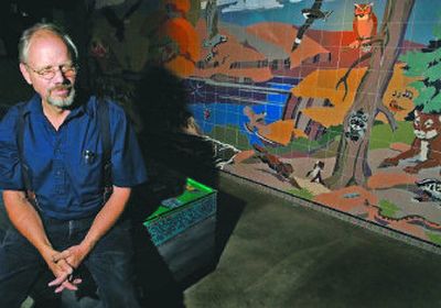 
Ken Spiering sits next to his mosaic tile mural titled, 