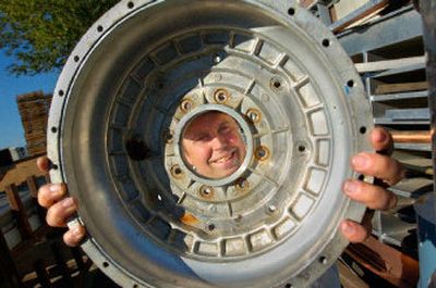 
Jim Schrock is framed in an aluminum auto wheel at Earthworks Recycling, which is featured in the Go Green Directory, below. His motto is 