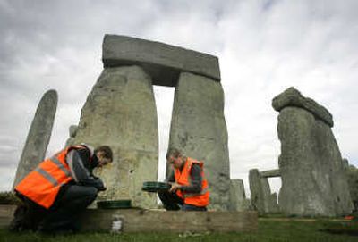 
Archaeology students Sam Ferguson, left, and Steve Bush sift through earth at Stonehenge, England, recently. Research indicates the site served as a burial ground from its earliest beginnings. Associated Press
 (Associated Press / The Spokesman-Review)