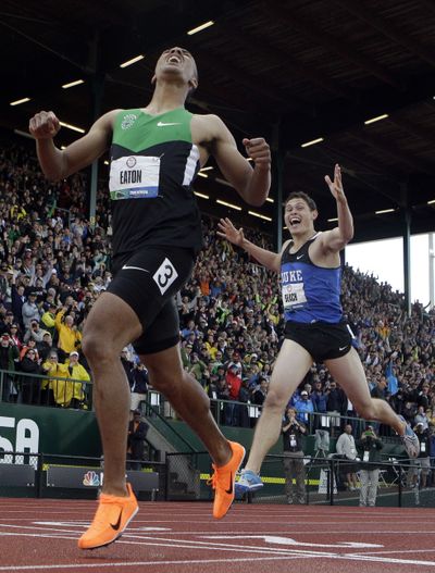 Ashton Eaton crosses the finish in the 1,500 meters, ahead of Curtis Beach, to set world decathlon record. (Associated Press)