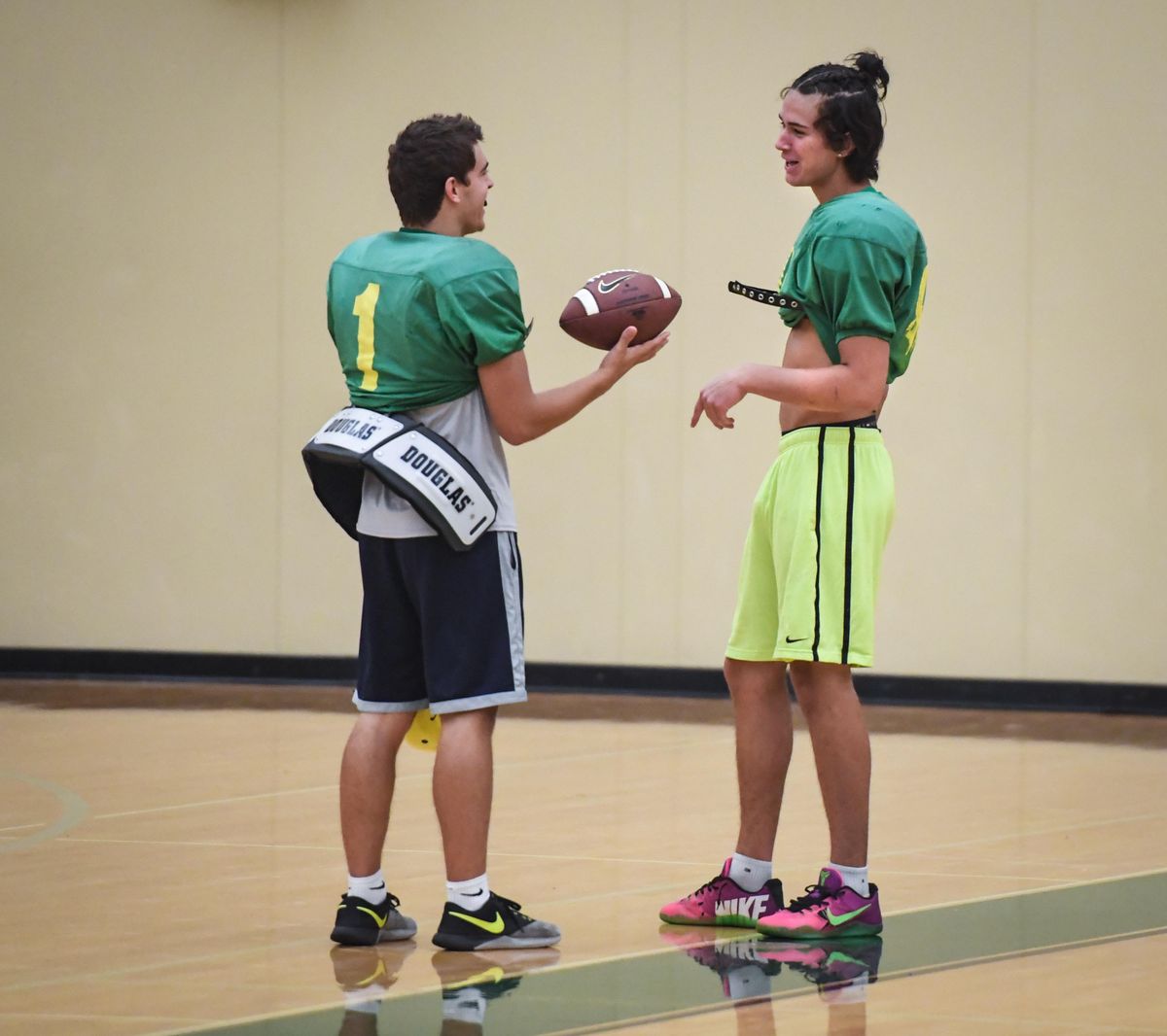 Shadle Park High School quarterback Carson Doyle, left, and wide receiver Xavier Atkins gather before practice, Wednesday, Aug. 22, 2018. (Dan Pelle / The Spokesman-Review)