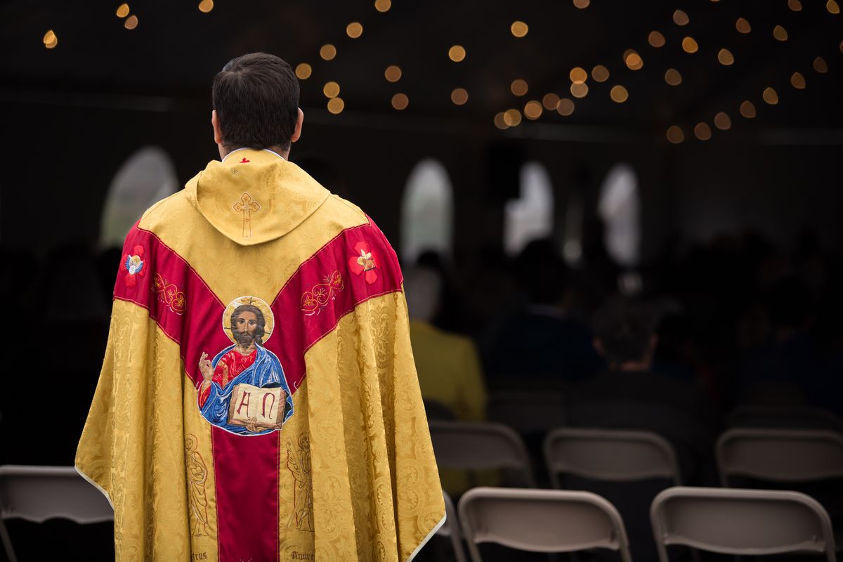 Rev. Esteban Soler looks on prior to beginning the Easter Sunday Mass in a tent outside of St. Charles School on Sunday. The school suffered major damage from a fire that was allegedly arson last month but was able to rise above the challenges and hold a full service for Resurrection Sunday.  (Libby Kamrowski/ THE SPOKESMAN-REVIEW)