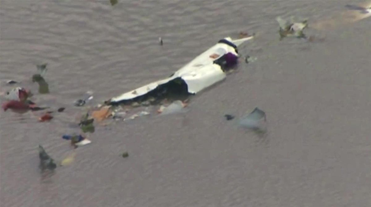 This image taken from video provided by KRIV FOX 26 shows the scene of a cargo plane crash on Saturday, Feb. 23, 2019, in Trinity Bay, just north of Galveston Bay and the Gulf of Mexico in Texas. (Associated Press)