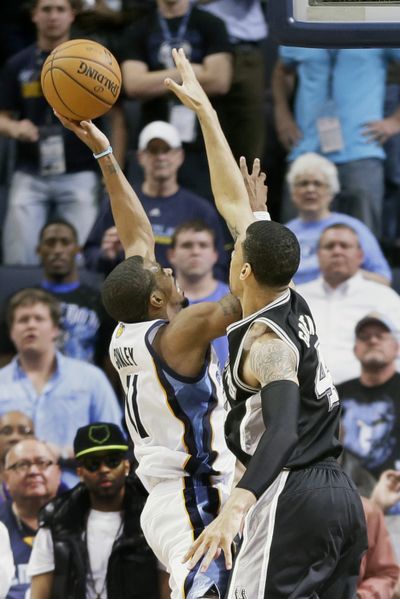 The outscretched arm of San Antonio’s Danny Green, right, can’t block Mike Conley’s game-winning layup with 0.6 seconds left. (Associated Press)