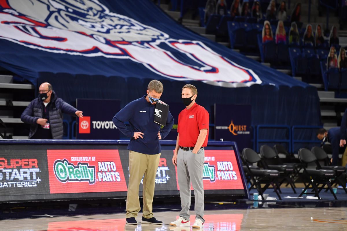 Gonzaga Bulldogs head coach Mark Few and San Diego Toreros head coach Sam Scholl chat after the second half of a college basketball game on Saturday, February 20, 2021, at McCarthey Athletic Center in Spokane, Wash. Gonzaga won the game 106-69.  (Tyler Tjomsland/THE SPOKESMAN-RE)