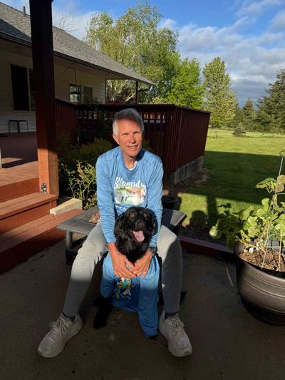 Rick Serns and his dog, Charlie, together sport Bloomsday shirts. Serns will be singing the national anthem ahead of the 50th race.  (Courtesy Rick Serns)