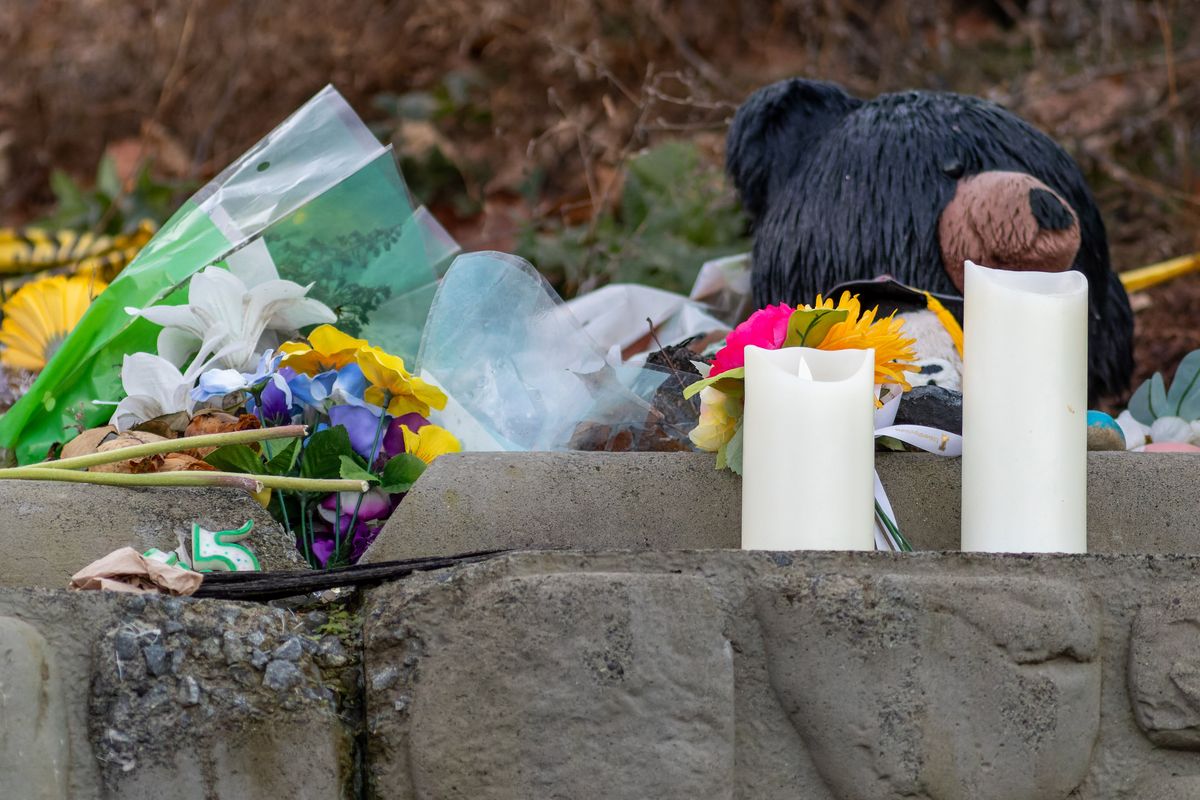 Items left in memory of Idaho students Madison Mogen, Kaylee Goncalves, Xana Kernodle and Ethan Chapin sit on a concrete block outside the home where they were stabbed to death last November on Thursday, Dec. 28, 2023, in Moscow, Idaho.  (Geoff Crimmins/For The Spokesman-Review)