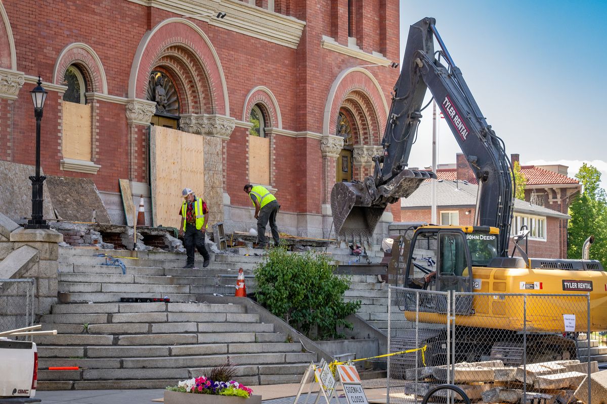 Workers remove the top stone steps during the renovation of the front  (COLIN MULVANY /THE SPOKESMAN-REV)