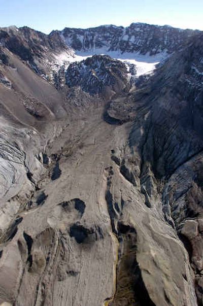 
The main crater and lava dome of Mount St. Helens are shown from the air Wednesday looking south into the mountain. Mount St. Helens began rumbling more intensely Wednesday, prompting scientists to raise the eruption warning level and suggest that ash and rock from a blast could land as far as three miles away.
 (Associated Press / The Spokesman-Review)