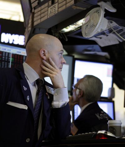 In this Oct. 3, 2011, photo, traders work on the floor at the New York Stock Exchange. Stocks slid again today as Europe's debt crisis showed few signs of being solved any time soon and officials said Greece will have to wait until November to get its hands on much-needed bailout cash. (AP/Seth Wenig)