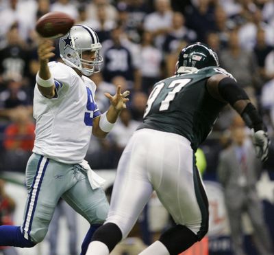 Dallas quarterback Tony Romo feels the pressure from Philadelphia’s Brodrick Bunkley on this first- quarter pass.   (Associated Press / The Spokesman-Review)