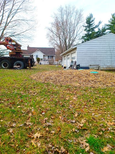 The green discs visible in the straw are service lids to a septic tank that was installed too high. As a result of this preventable error, the sewage line from the house to the tank did not have the required pitch called for in the plumbing code.  (Tribune Content Agency)