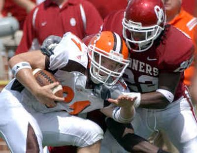 
Oklahoma defender Chijoke Onyenegecha impedes the progress of Bowling Green wide receiver Cole Magner on Saturday.  
 (Associated Press / The Spokesman-Review)