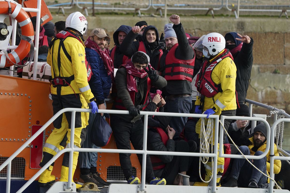 A group of people thought to be migrants are brought in to Dover, Kent, Britain, by the RNLI following a small boat incident in the Channel, Tuesday Jan. 4, 2022. At least 28,300 people packed into small boats crossed the Channel from France to England’s south coast in 2021, an annual record that was three times the number of crossings a year earlier. The leap in numbers, reported by the Press Association news agency based on data from Britain