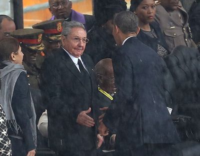 President Barack Obama shakes hands with Cuban President Raul Castro in Soweto, South Africa, for a memorial service for former South African President Nelson Mandela on Tuesday. (Associated Press)