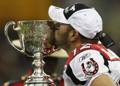 Calgary kicker Sandro DeAngelis plants one on the Grey Cup.  (Associated Press / The Spokesman-Review)