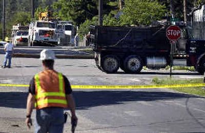 
A dump truck knocked down power lines at the corner of Fourth and Bradley on Thursday. Crews worked through the morning to restore power to the neighborhood. 
 (Photos by Liz Kishimoto/ / The Spokesman-Review)