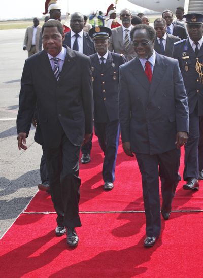 Benin President Boni Yayi, left, arrives at the Felix Houphouet Airport in Abidjan on Tuesday.  (Associated Press)