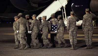 The casket of Air Force Staff Sgt. Phillip Myers, of Hopewell, Va., who was killed in Afghanistan on Friday, is carried off a plane by an honor guard Sunday at Dover Air Force Base, Del.  (Associated Press / The Spokesman-Review)