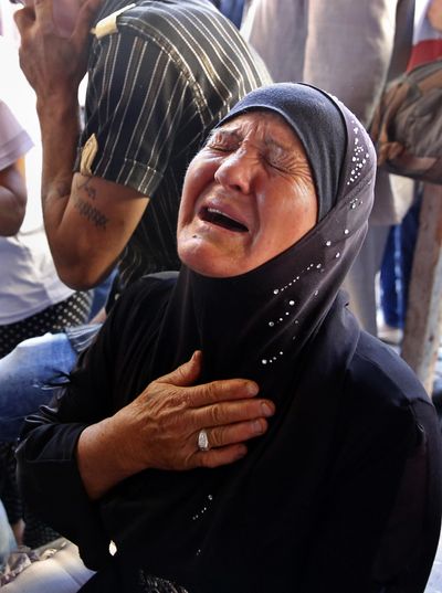 The mother of Mustafa Ali Wehbe, who was kidnapped by Islamic State group militants, weeps in a tent set up in downtown Beirut, Lebanon, Sunday, Aug. 27, 2017. (Bilal Hussein / Associated Press)